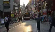 Bus in the middle of a small busy street in Tokyo