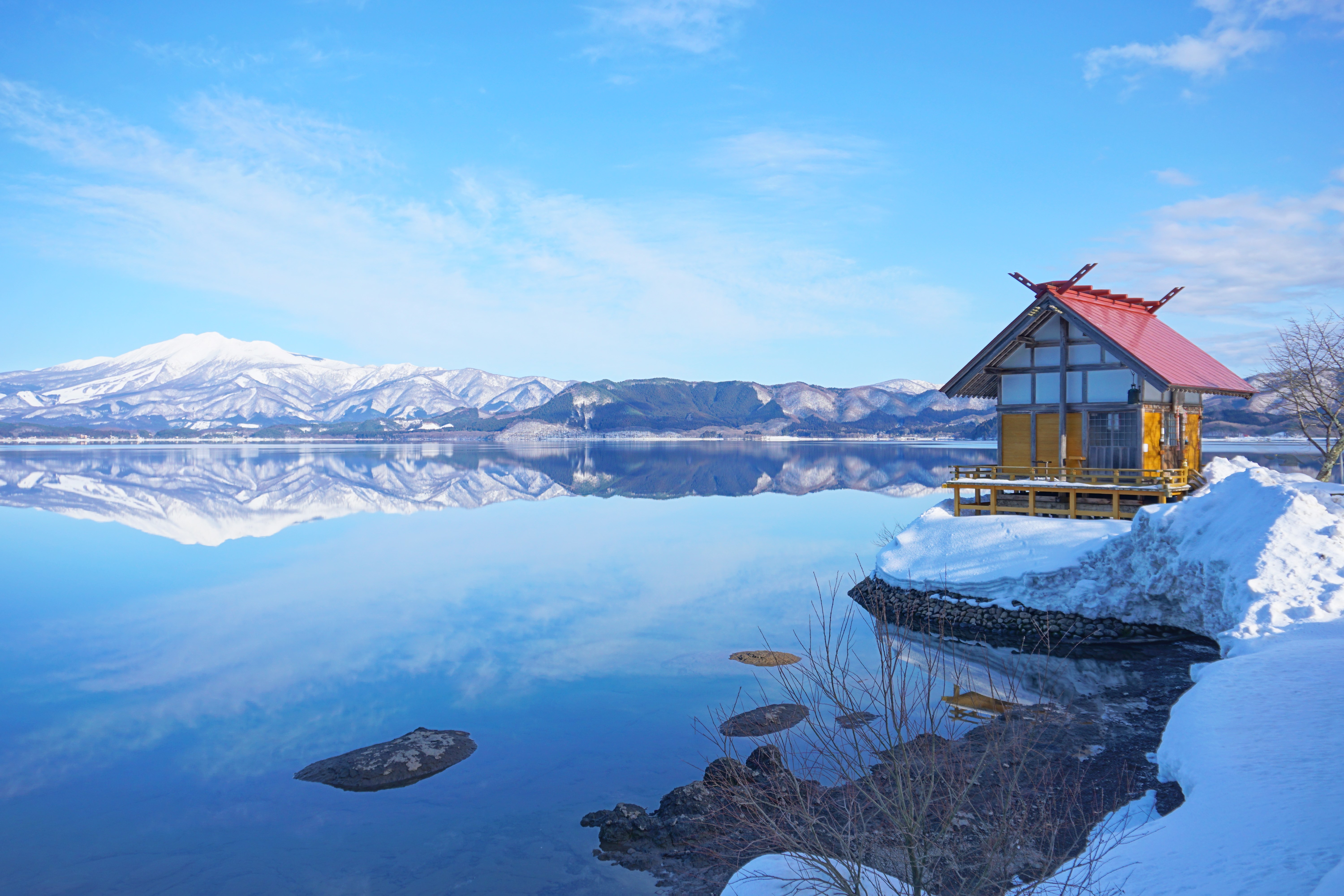 Kansaki Palace stands on Lake Tazawa & the lakeside, & beyond the lake, there’s a distant view of Mt. Akita Komagatake (Semboku City, in Akita Prefecture).
