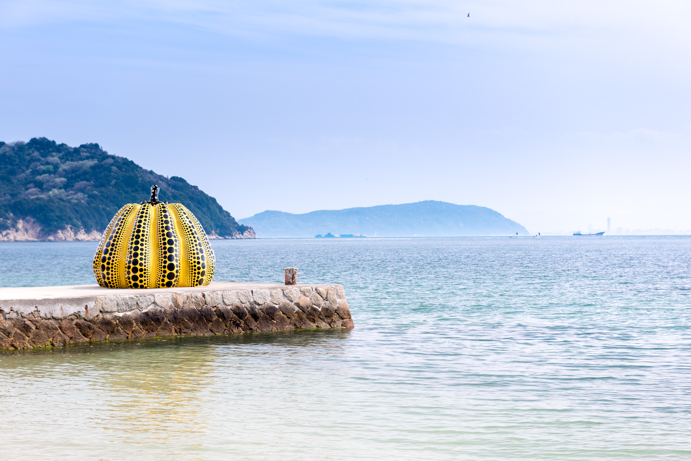 Yayoi Kusama's yellow pumpkin, the symbol of Naoshima, a must-visit art island in the Seto Inland Sea.