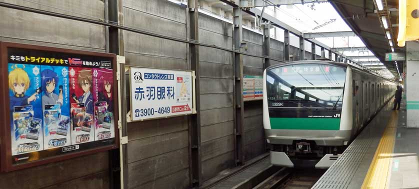 Saikyo Line train and manga-themed advertisement at Akabane Station, Kita Ward, Tokyo.