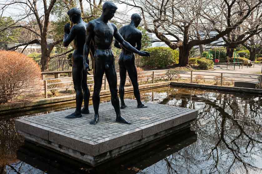 Pond with statues in Chidorigafuchi Park.