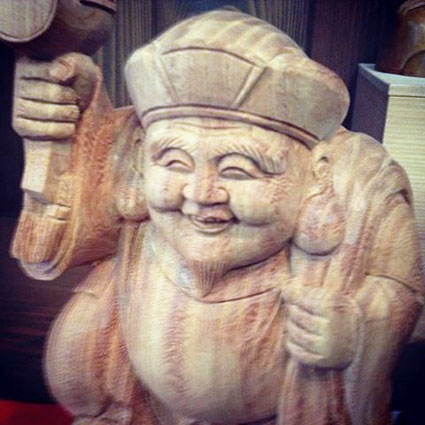A wooden statue of Daikoku with his magic hammer.