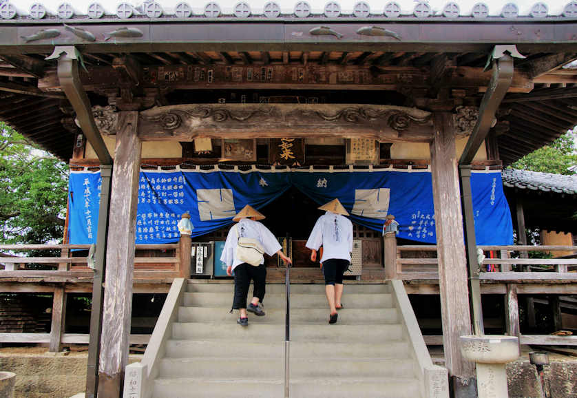 A pair of young pilgrims ascend the steps up to the Main Hall at Horinji Temple.