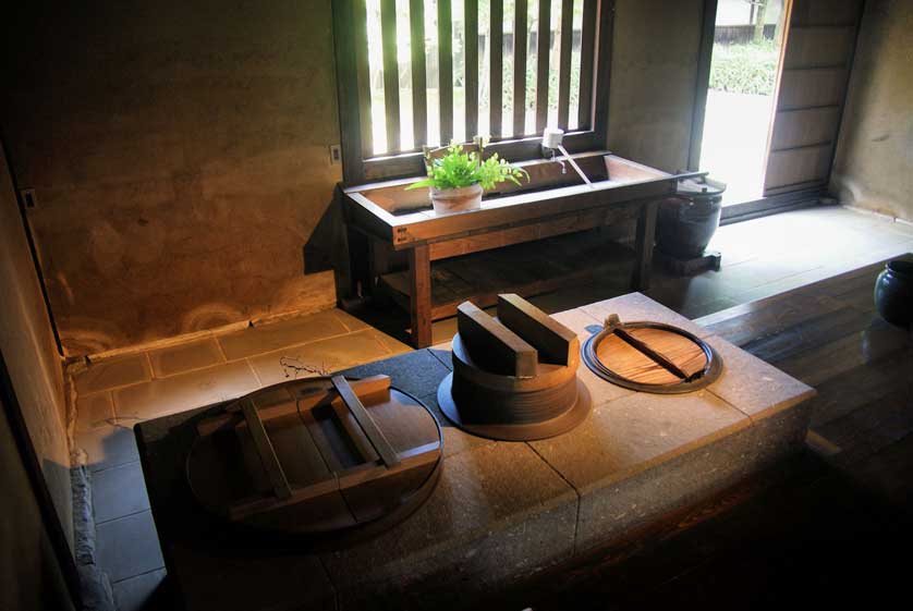 Kitchen with kamado stove at Hosokawa Gyobutei, Kyushu, Japan.