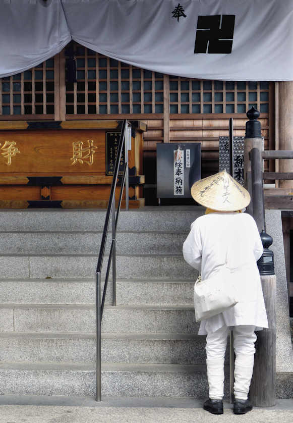 A lone pilgrim prays at Kannonji Temple, the 16th of the 88 temples of the famous Henro pilgrimage, Shikoku.