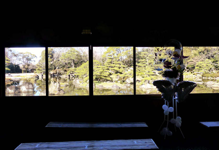 Time for a rest and to enjoy the view from the waterside pavilion at Keitakuen Garden, Osaka, Japan