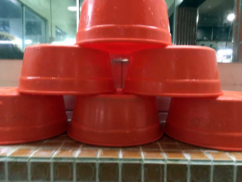 Bathhouse interior showing plastic buckets using for washing.