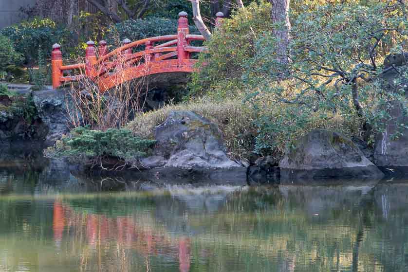 Vermilion arched bridge over the pond in Kyu-Yasuda Teien Garden, Yokoami-cho, Sumida ward, Tokyo.