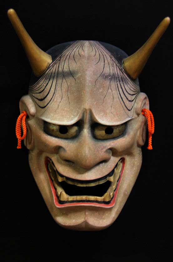 A modern, wooden Hannya mask.