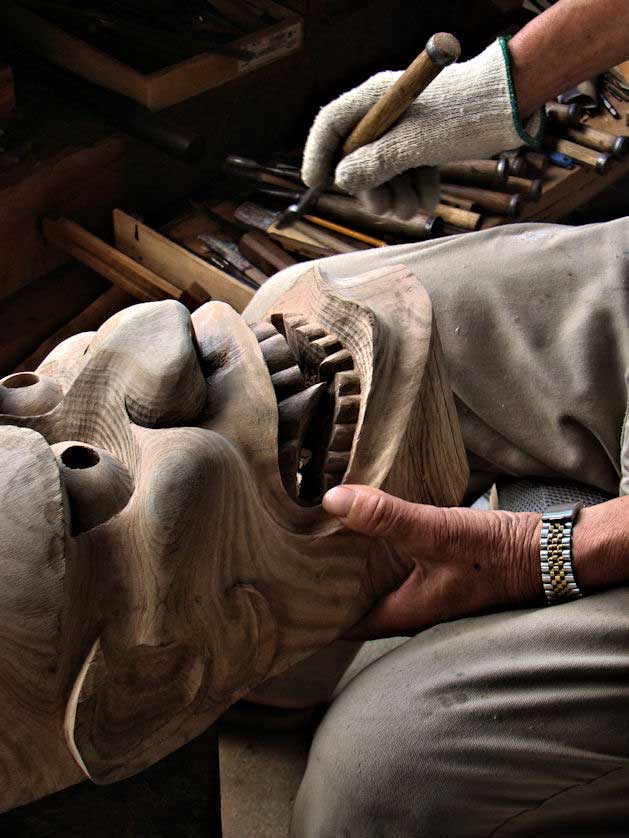 A mask maker carving a Hannya mask, Kunisaki, Oita.