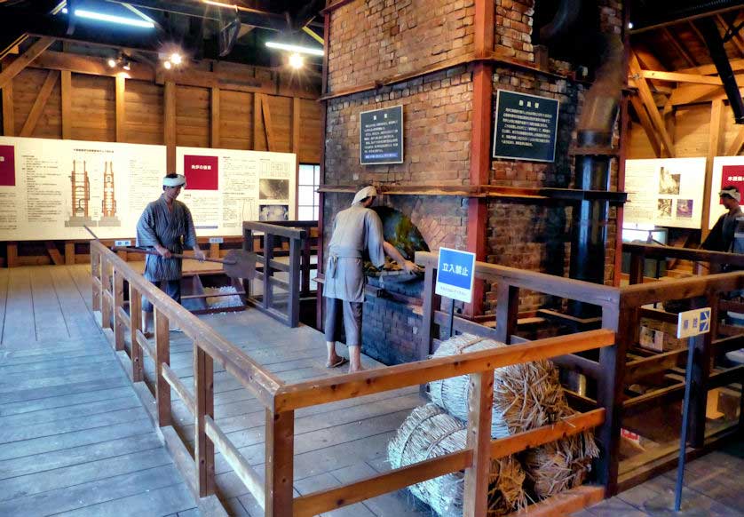 The upper floor of the Tatara Lore Museum with mannequins  and many displays showing iron production.