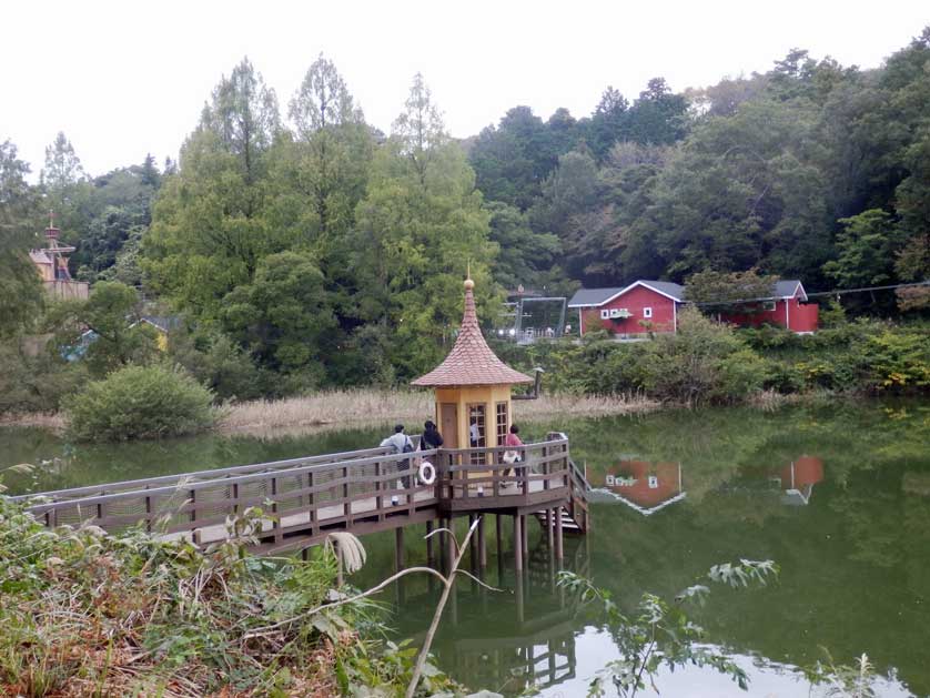 View over Lake Miyazawa to parts of Moomin Valley Park with the Uimahuone (bath house) in the foreground.