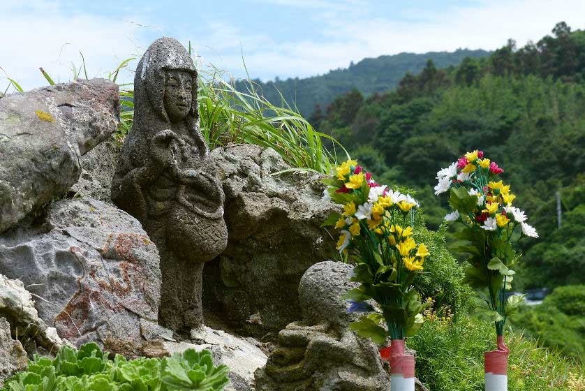 Statue of the Goddess of Mercy, Kannon, on the clifftop at Motonosumi Inari Shrine.