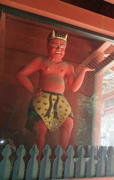 Red demon at the gate of the main shrine building.