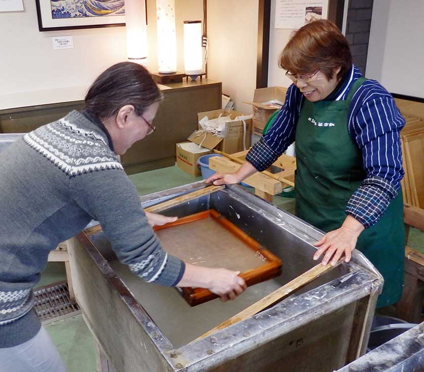 A visitor scoops paper pulp, Saitama Craft Center, Ogawa.