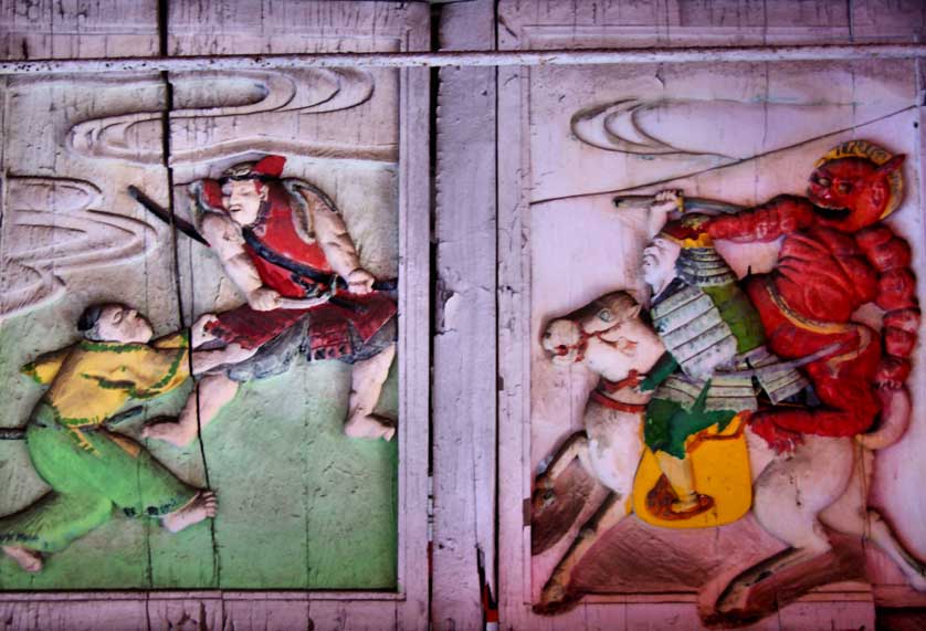 Brightly colored relief carvings adorn the main gate of Yasaka Shrine in Oita City.