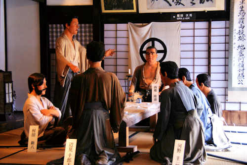 Saigo Takamori at the head of the table with his closest followers, Henmi Jurota, Kono Keichiro, Ikegami Shiro, Beppu Shinsuke, Kirino Toshiaki, and Murata Shinpachi.