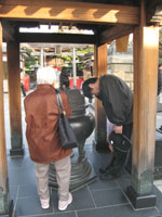 Supplicants annointing themselves with smoke at Fukagawa Fudoson, Tokyo.