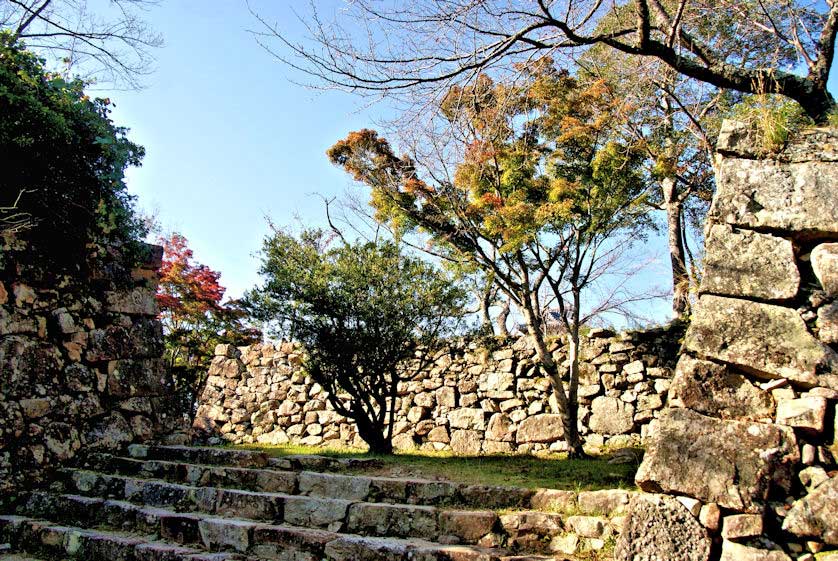 Signboard displaying the extensive stonework still existing at the Sumoto Castle ruins, Japan.
