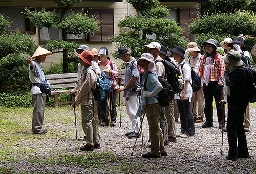 A guide prepares a group for a hike along the Kumano Kodo at Takijiri Oji.