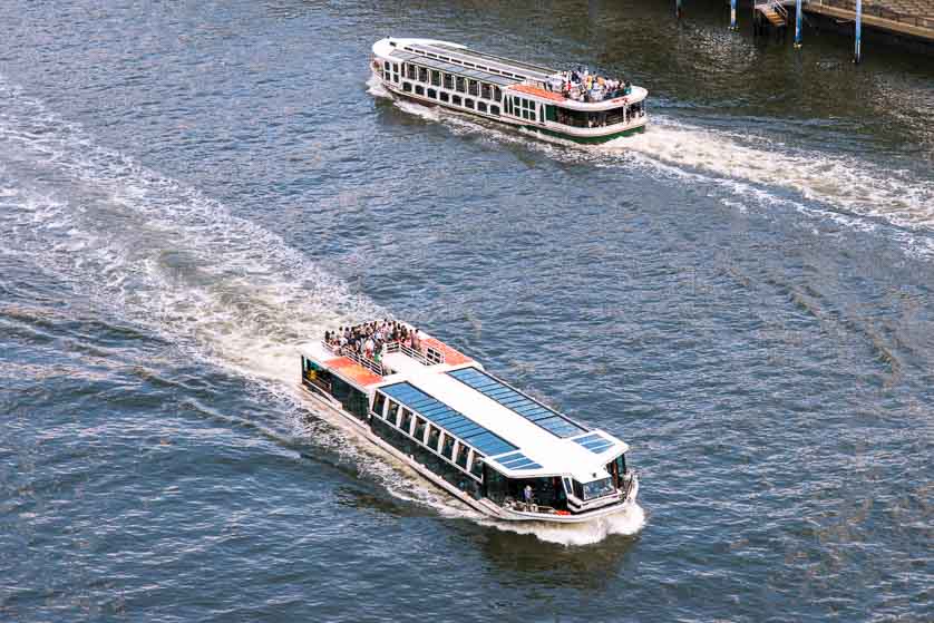 Two Tokyo Cruise Line cruise boats pass each other on the Sumida River, Tokyo.