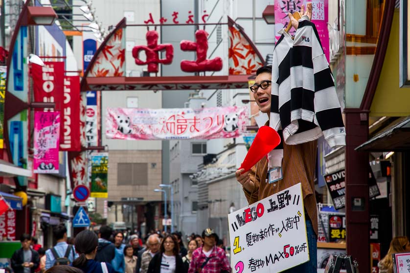 Promoting goods in front of an Uechun clothing store, Ueno, Tokyo.