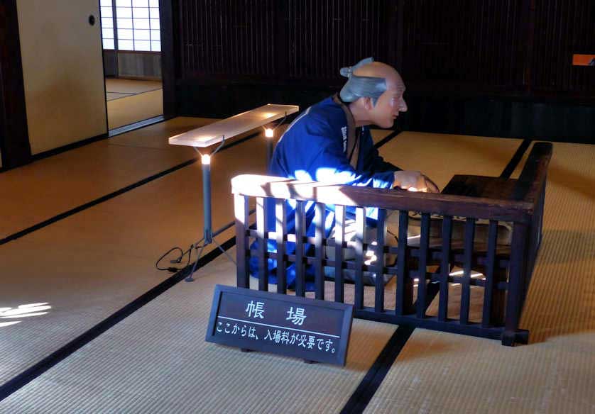 In the Yoshida House a tableau of Edo Period Japanese indigo merchant doing his accounts on an abacus, Shikoku, Japan.