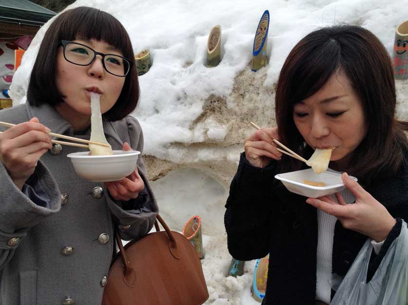 Enjoying fresh mochi at Wakuwaku Winter Festival, Niigata Prefecture.