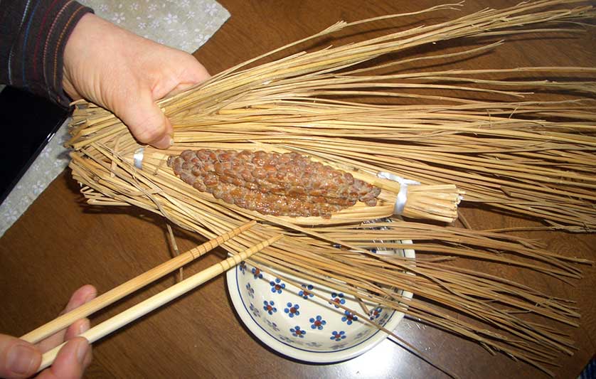 Opening a pack of wara natto, Ibaraki Prefecture, Japan.