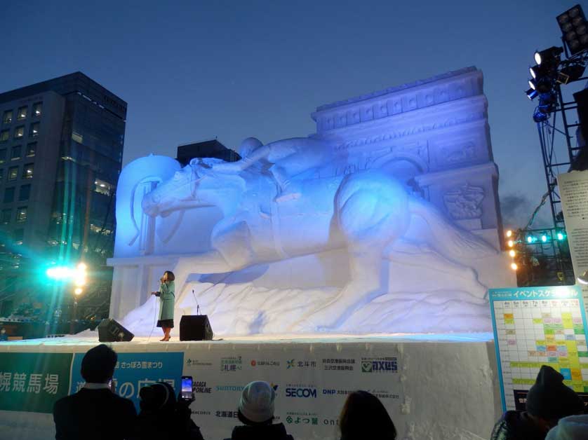 Evening concert in front of an illuminated snow sculpture, Sapporo Snow Festival.