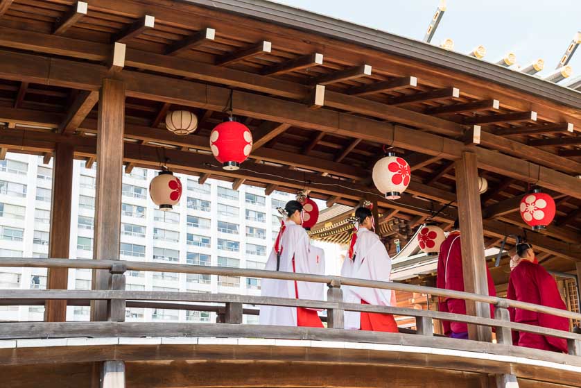 Priests crossing footbridge at Yushima Tenjin (Tenmangu) Shrine.