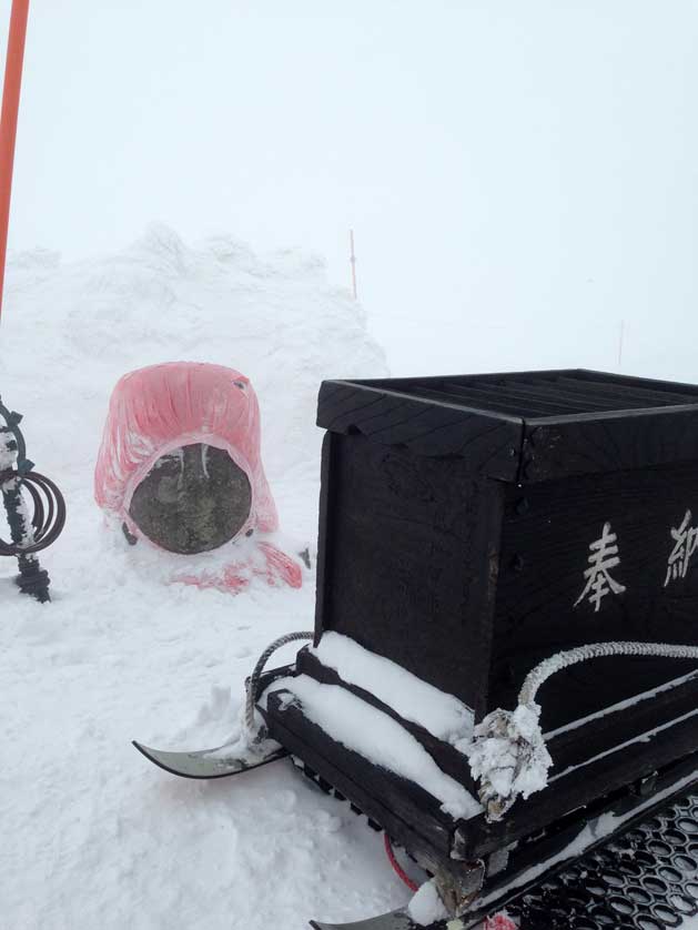 Buddhist Jizo Statue buried in snow.