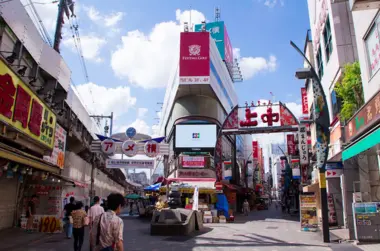 Two streets leading off the street with shops and signs 