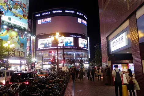 Yunika Building with its video screens in front of the main entrance of Seibu Shinjuku Station Yunika Building with its video screens in front of the main entrance of Seibu Shinjuku Station