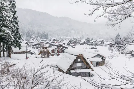 Shirakawago village in Winter with snow surrounding the homes and farmhouses