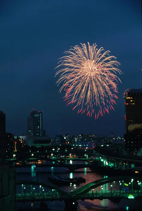 During the feast of Sumida, Tokyo sky glows blue, red yellow and lots of other colors.