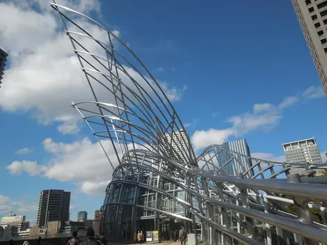 Creado por el arquitecto argentino César Pelli usando vigas de metal y placas de vidrio. Creado por el arquitecto argentino César Pelli usando vigas de metal y placas de vidrio.