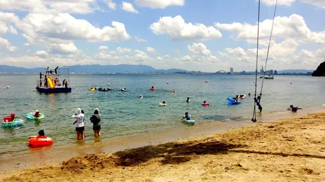 A beach on the island of Nokonoshima with the distant buildings of Fukuoka. A beach on the island of Nokonoshima with the distant buildings of Fukuoka.