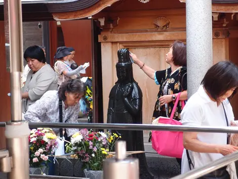 For the Koganji heal you must pour water from the fountain in front of the statue on a sore or tired your body part.