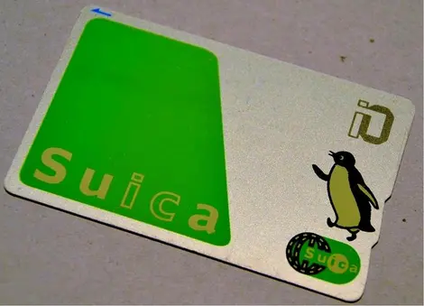 The Suica card, recognizable by its green color and baby penguin.