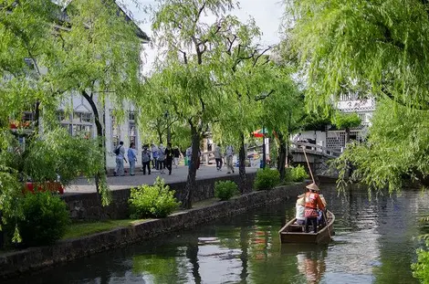 Tourists take a boat trip to Kurashiki.