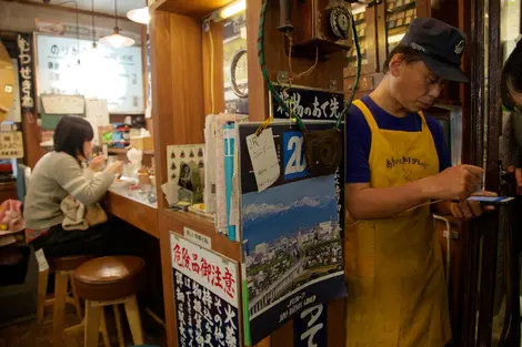Femme mangeant seule au comptoir du Niagara Curry House, le restaurant-train Femme mangeant seule au comptoir du Niagara Curry House, le restaurant-train