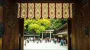 Door looking out to a crowded courtyard and torii 