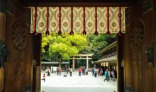 Door looking out to a crowded courtyard and torii 