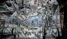 Different reflections from mirrors above an escalator in Omotesando