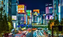 Neon lights of Shinjuku with car lights from a busy road