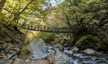 A rope bridge over a river in Iya Valley