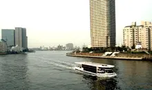 A barge Yakatabune between the buildings of Tokyo Bay.