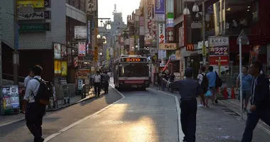 Bus in the middle of a small busy street in Tokyo