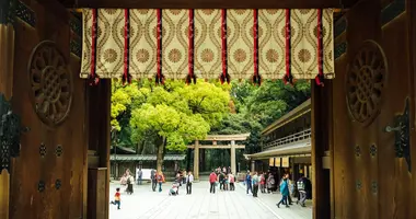 Door looking out to a crowded courtyard and torii 